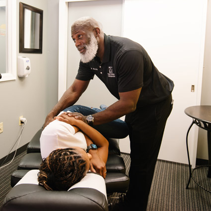 Dr. Phillip Nicolas adjusting a patient