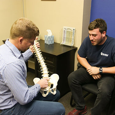 Dr. Suntken holding spine model