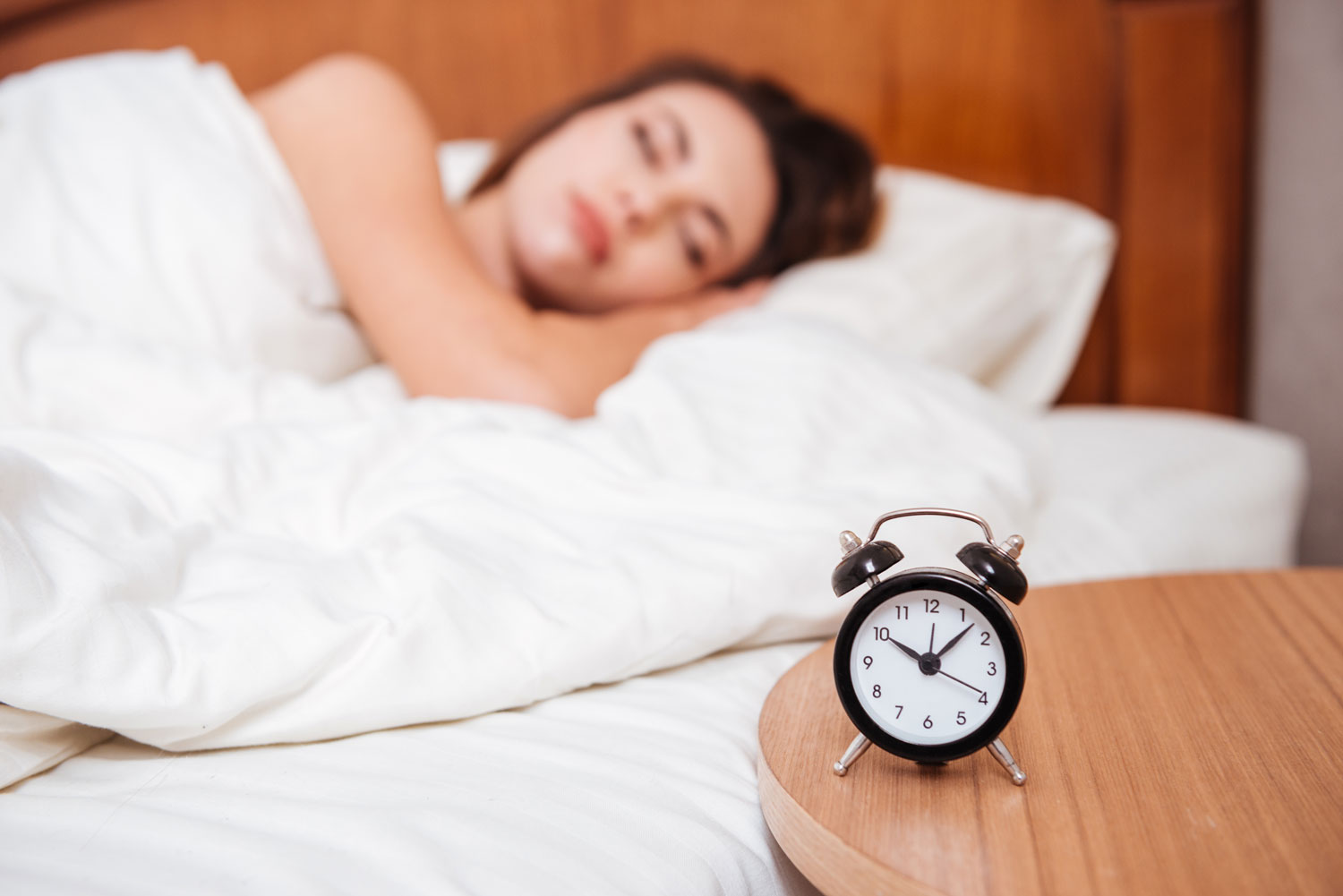 graphicstock-young-woman-sleeping-in-bed-in-her-bedroom-focus-on-alarm-clock_ruznzwIP3g