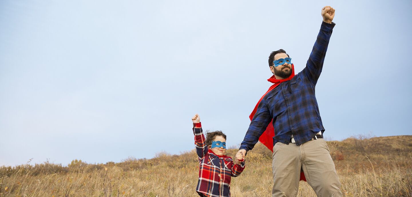 dad and son dressed as superheroes