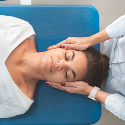 Woman getting her neck adjusted at a chiropractor