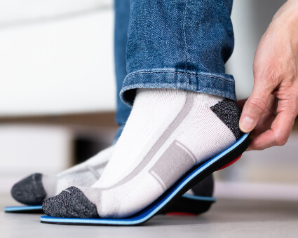 Man fitting orthotics