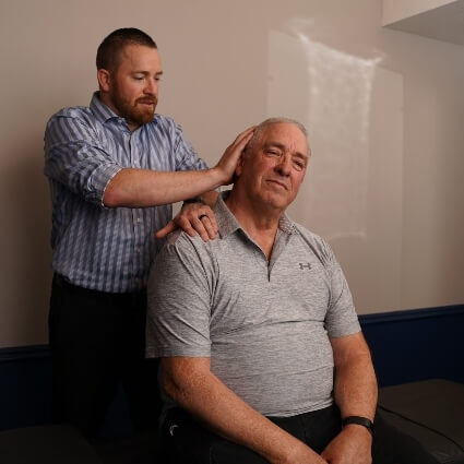 Male patient receiving a chiropractic neck adjustment