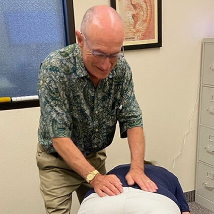 Dr. Wills with hands on low back