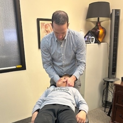 Dr Jackson adjusting childs neck