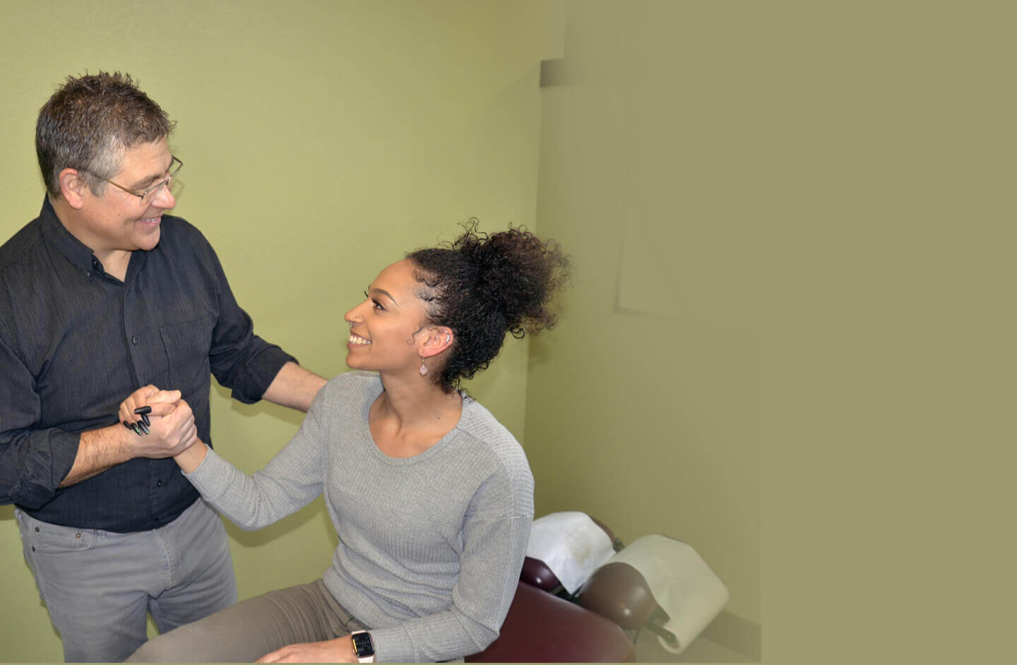 Bend chiropractor Dr. Dan in consultation with female patient