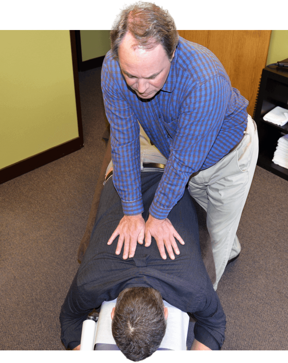 Bend Chiropractor Dr. Dan adjusting upper back