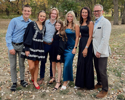 Dr Dixon and family smiling outdoors