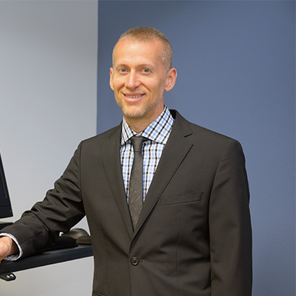 Dr. Ryan Sweet, Chiropractor in Lacey, standing at front desk