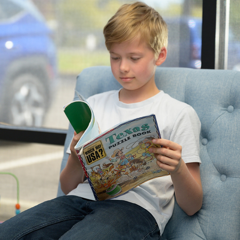 kid reading magazine