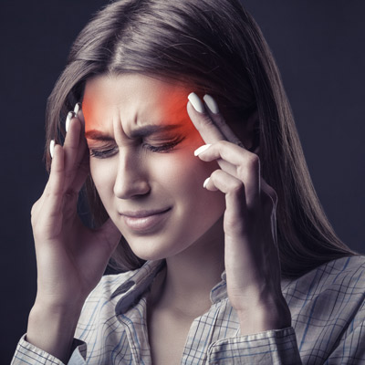 woman grimacing from headache