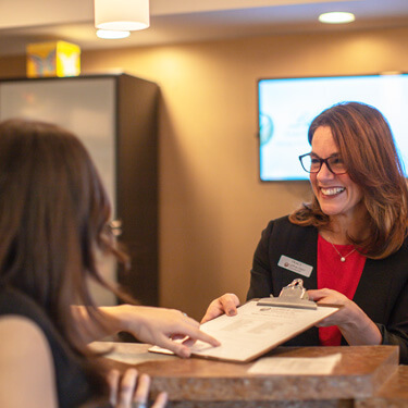 patient-with-forms-at-front-desk