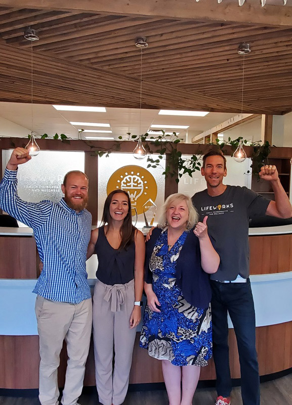 excited team photo at frontdesk