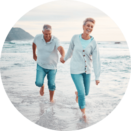 older couple walking on the beach