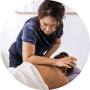 massage therapist with female patient