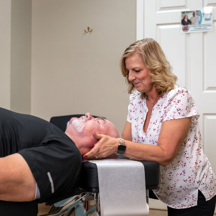 Adjusting man's neck