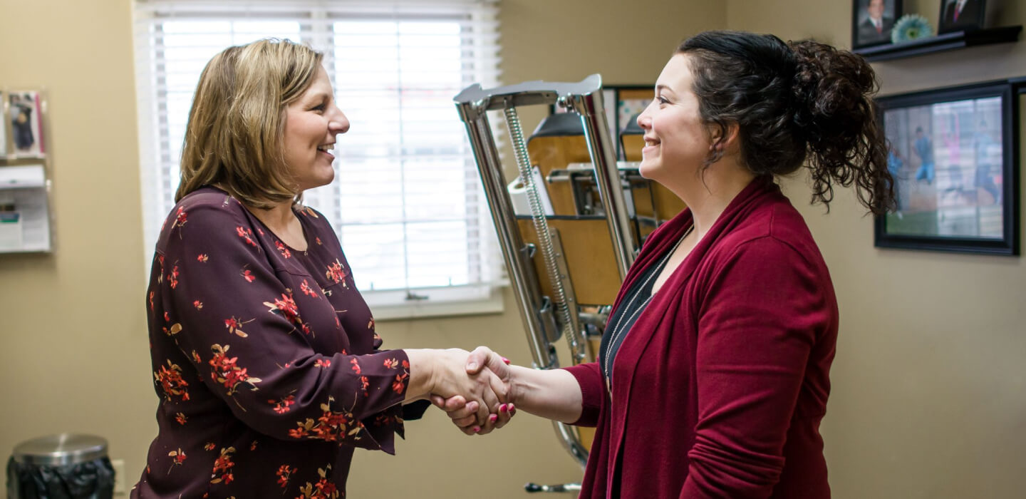 Dr. Jung shaking hands with female patient