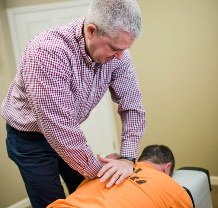Dr. Hiatt adjusting man's back
