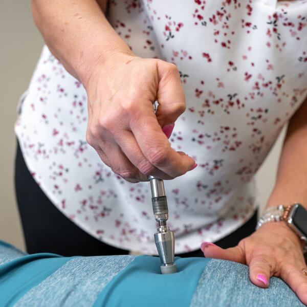 Dr. Hiatt adjusting woman's neck