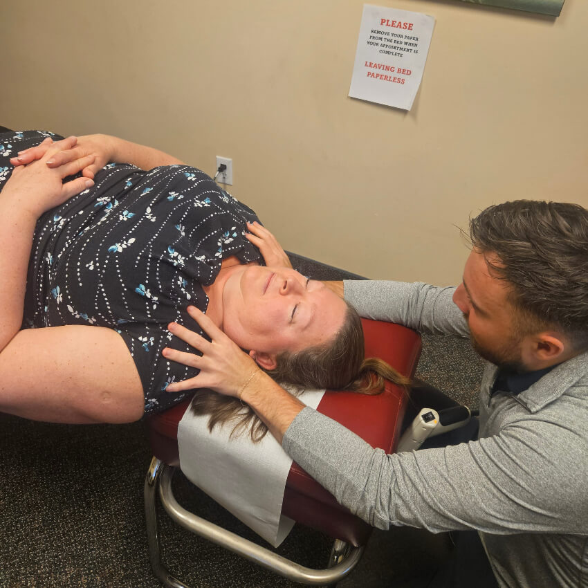 Adjusting woman on table