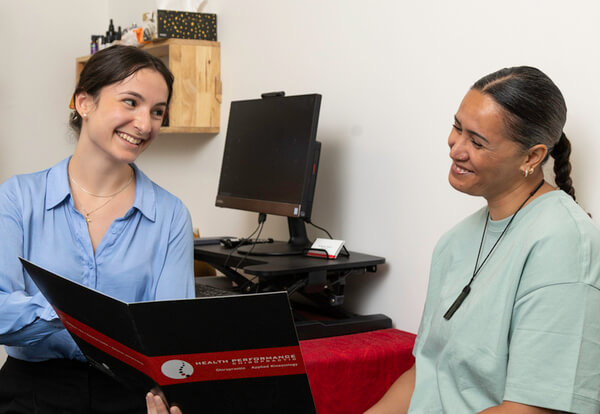 Hamilton patient in a chiropractic consultation at Health-Performance Chiropractic