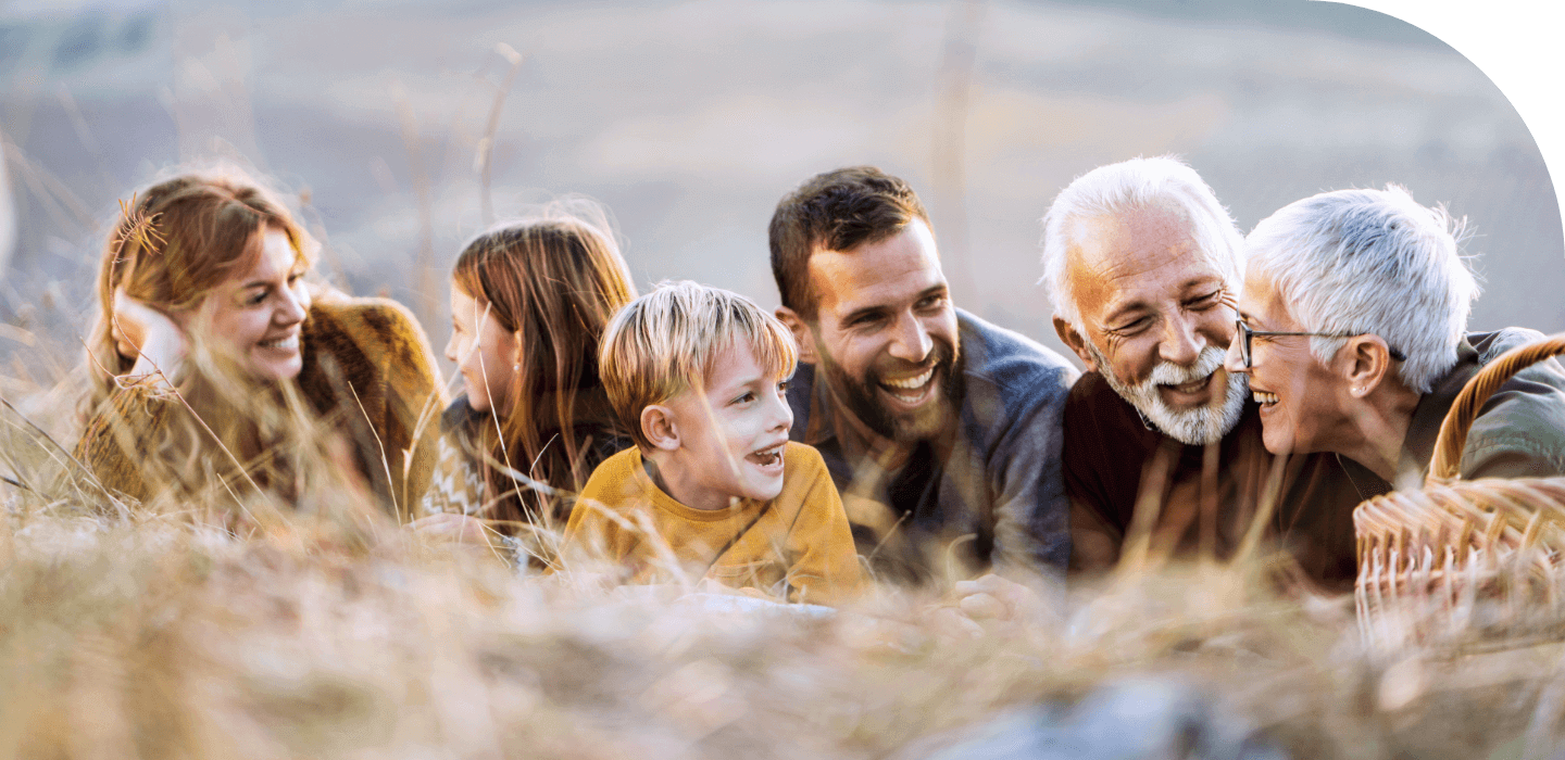 Smiling multi-generational family out in nature