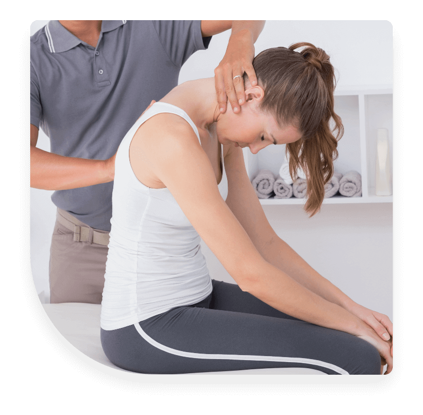 Male chiropractor adjusting female patient