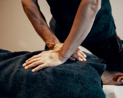 Male chiropractor adjusting female patient