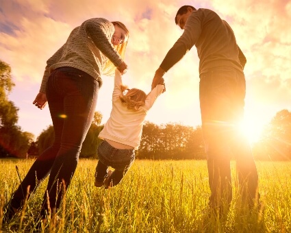 Young family out in nature during sunset