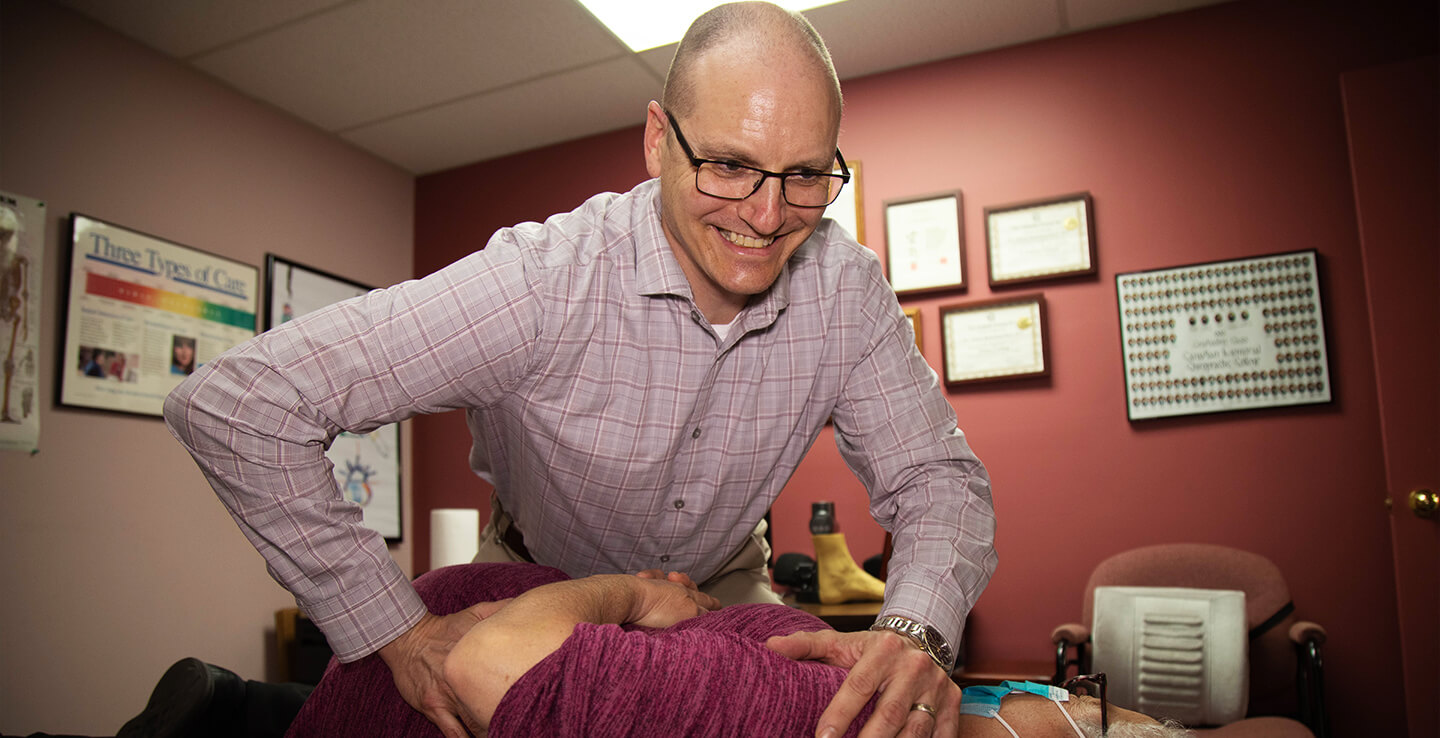 Dr. Adrian Robichaud adjusting patient