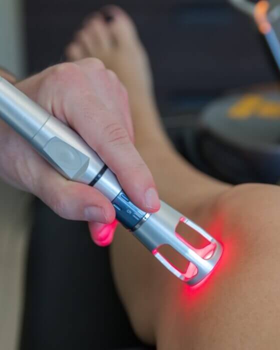 doctor using laser therapy on a patient