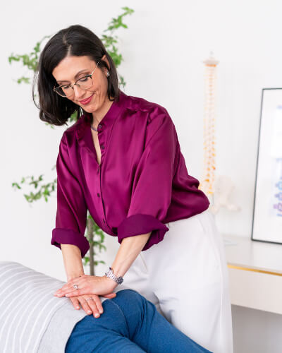 Dr Jodi adjusting patients lower back