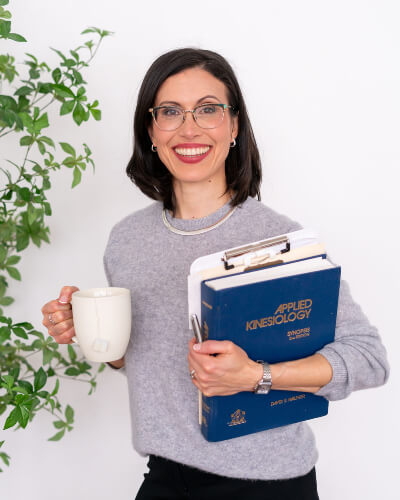 Dr. Jodi holding books and coffee