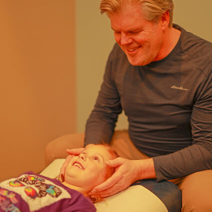 Dr. Michael Salmon adjusting child