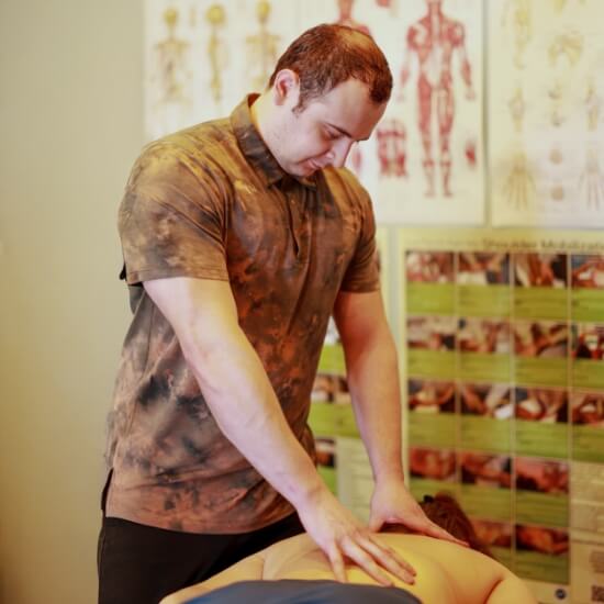 Vernon Chiropractic and Massage Massage therapist Corey working with patient
