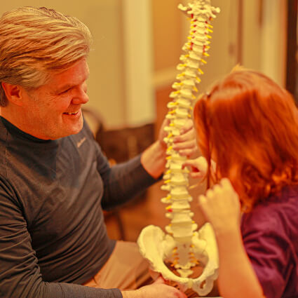 Vernon Chiropractor Dr. Michael Salmon holding spine model