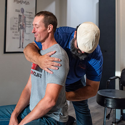 Doctor adjusting man's back