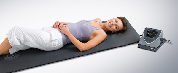 woman on mat receiving BEMER therapy