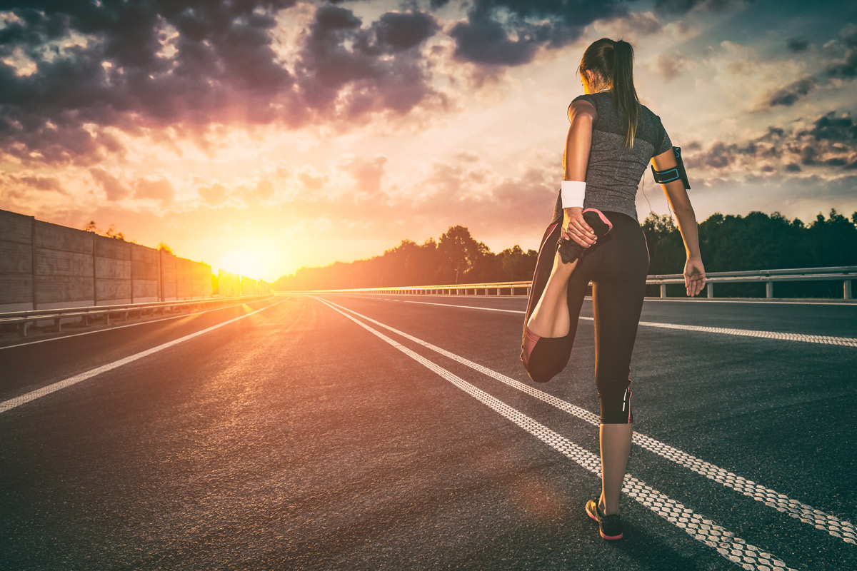 Woman stretching on the pavement