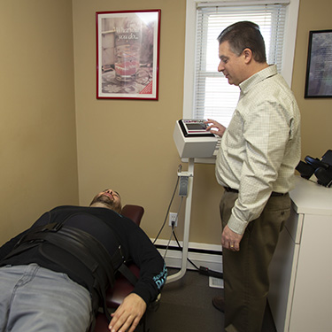 Man on spinal decompression table doctor onlooking