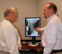 Dr. Warren reviewing X-rays with a patient