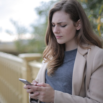 woman reading phone stressed