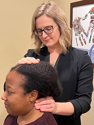 Dr Erin adjusting female patients neck