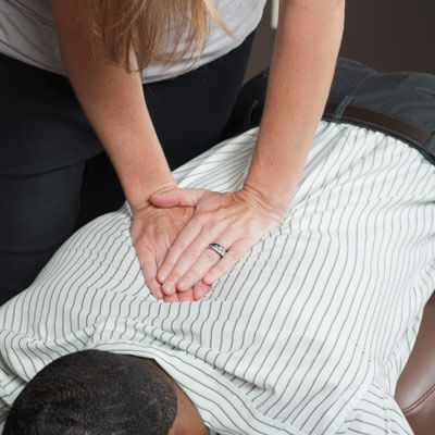 Chiroprqactor adjusting patient's back