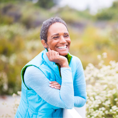 older active woman smiling outdoors