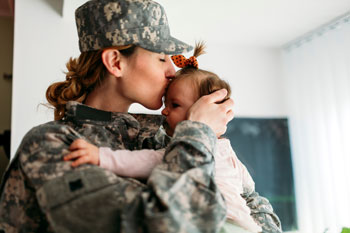 military-mom-kissing-daughter