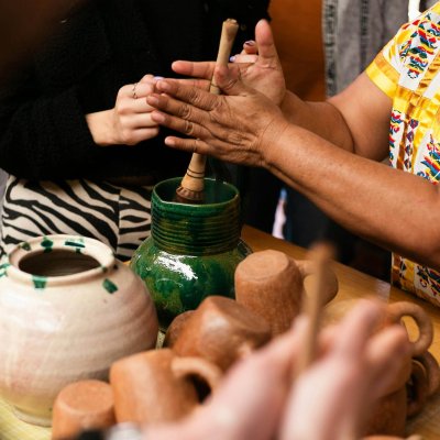 Close-up of artisans crafting handmade pottery in Oaxaca, showcasing local craftsmanship.