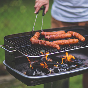 Man grilling sausages on a grill