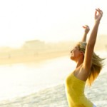 woman-arms-up-beach