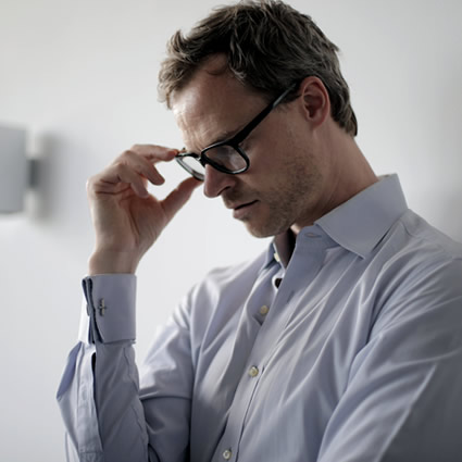 man stressed wearing eyeglasses